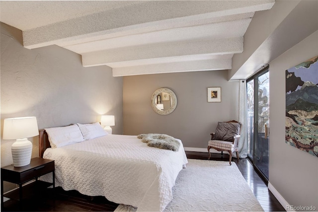 bedroom featuring beamed ceiling, baseboards, and wood finished floors