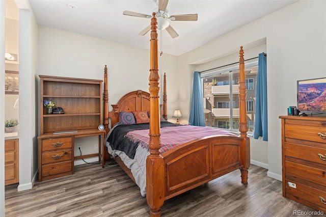 bedroom with dark wood-type flooring, ceiling fan, and connected bathroom