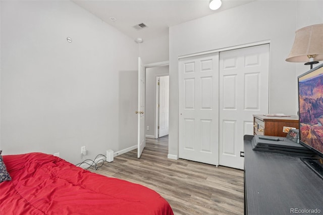 bedroom with wood-type flooring and a closet