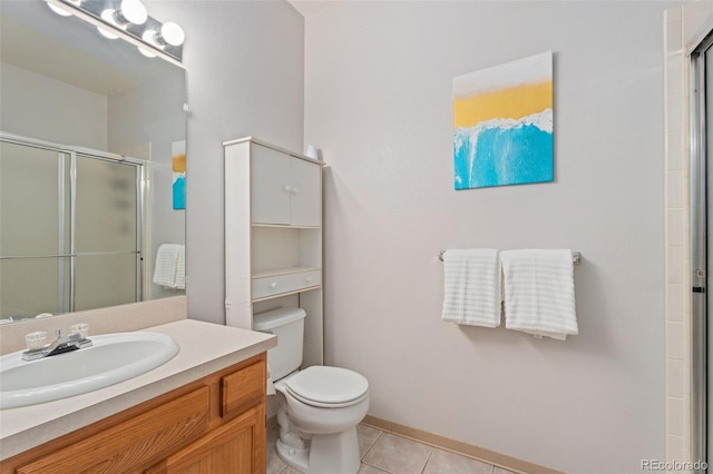 bathroom featuring vanity, toilet, a shower with shower door, and tile patterned flooring