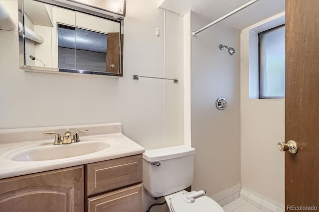 bathroom featuring a shower, toilet, and vanity