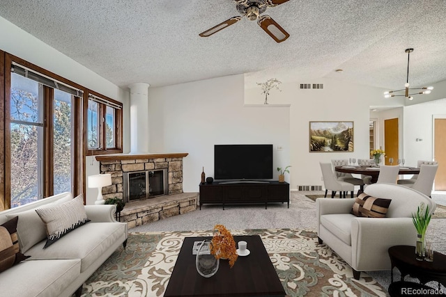 carpeted living room featuring visible vents, a textured ceiling, a stone fireplace, and vaulted ceiling