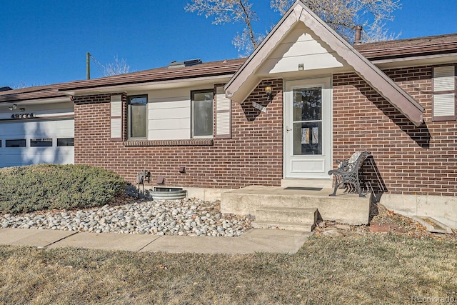 view of front of property with brick siding and a garage