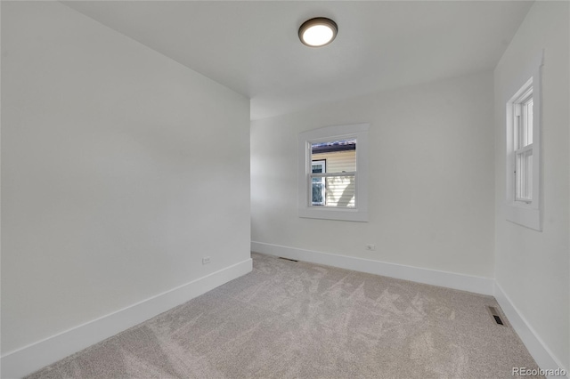 empty room featuring light carpet