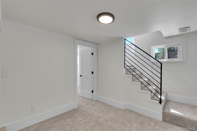 interior space with carpet and a textured ceiling