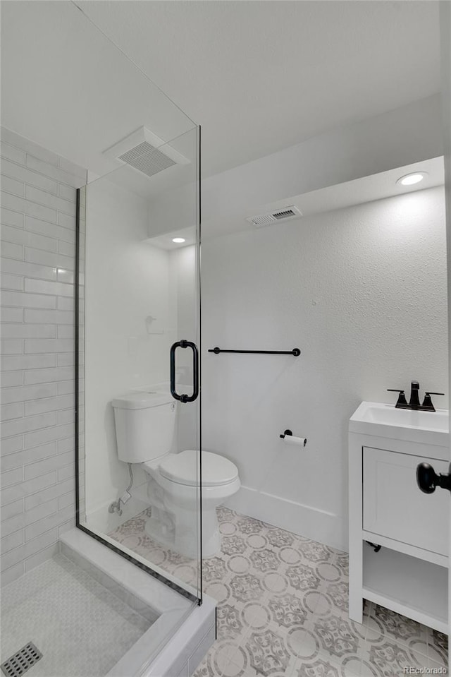 bathroom with vanity, toilet, and an enclosed shower