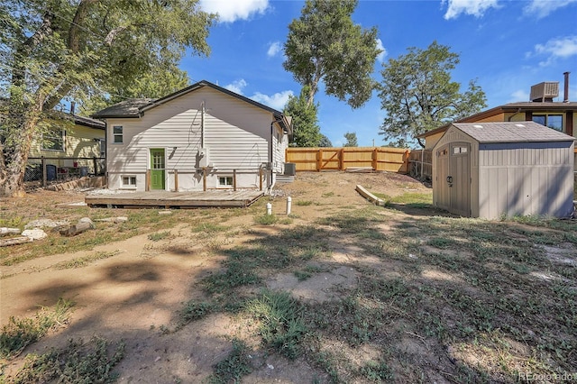 view of yard featuring a storage shed and a deck