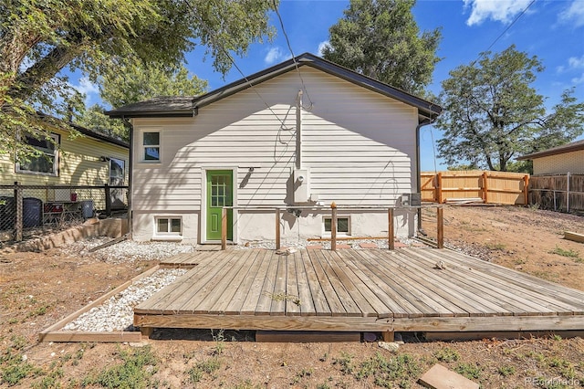 back of house featuring a wooden deck