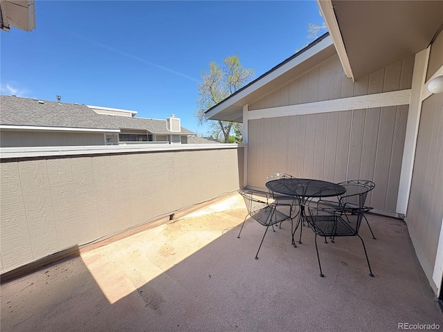 view of patio featuring outdoor dining space and a balcony