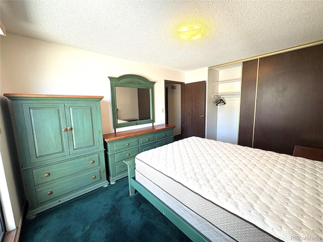 bedroom with a closet, dark carpet, and a textured ceiling