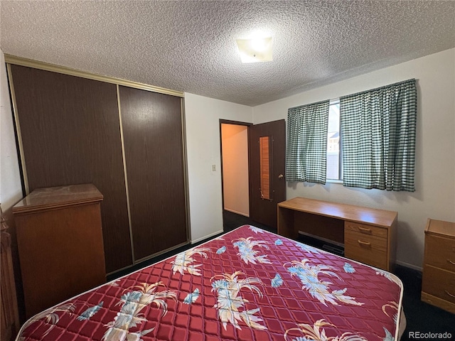 bedroom with a textured ceiling and a closet