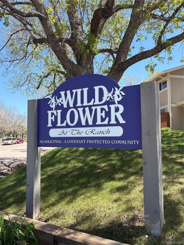 community / neighborhood sign featuring a lawn