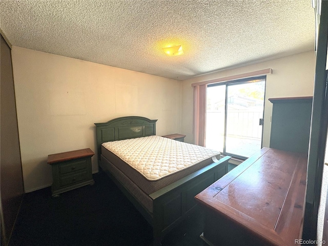 bedroom featuring access to outside and a textured ceiling