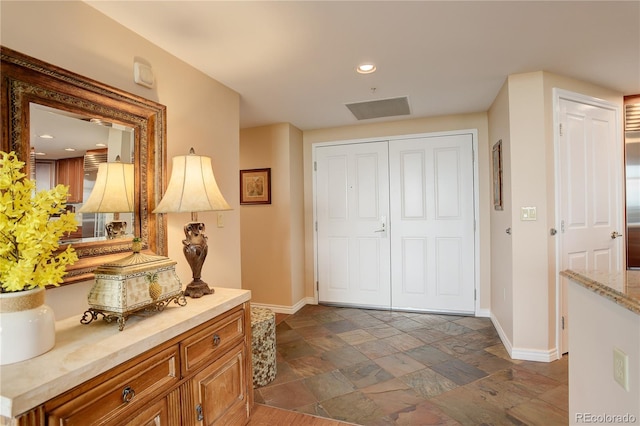 8100 E Union Ave Unit 1502, Denver, CO 80237 - entryway featuring baseboards, stone tile floors, and recessed lighting