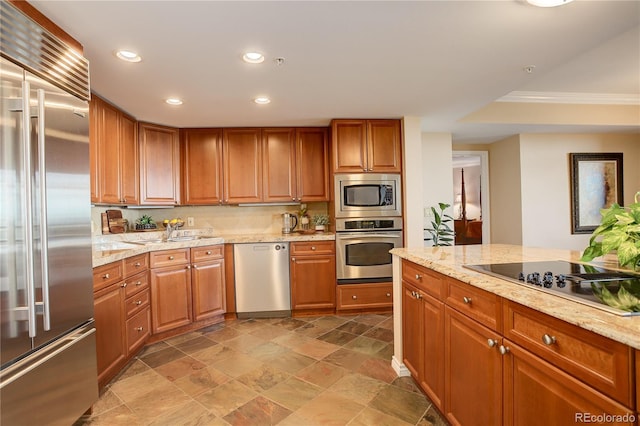 8100 E Union Ave Unit 1502, Denver, CO 80237 - kitchen with appliances with stainless steel finishes, recessed lighting, a sink, brown cabinets, and light stone countertops