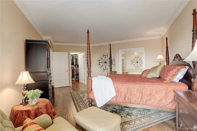 8100 E Union Ave Unit 1502, Denver, CO 80237 - bedroom featuring wood-type flooring, crown molding, a walk in closet, ensuite bathroom, and a closet