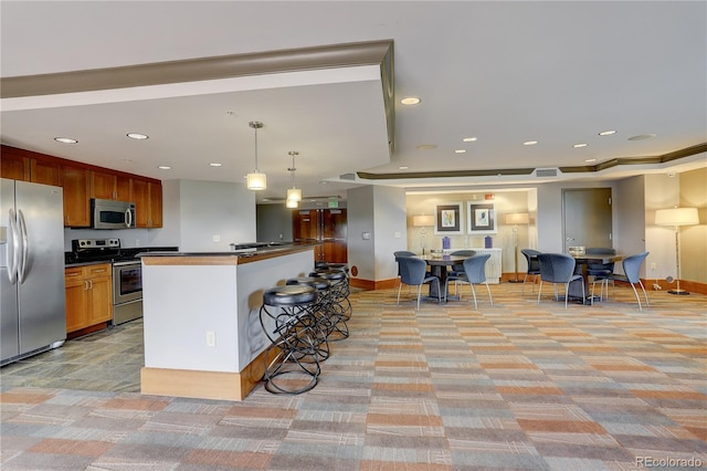 8100 E Union Ave Unit 1502, Denver, CO 80237 - kitchen featuring stainless steel appliances, light colored carpet, dark countertops, a breakfast bar, and baseboards