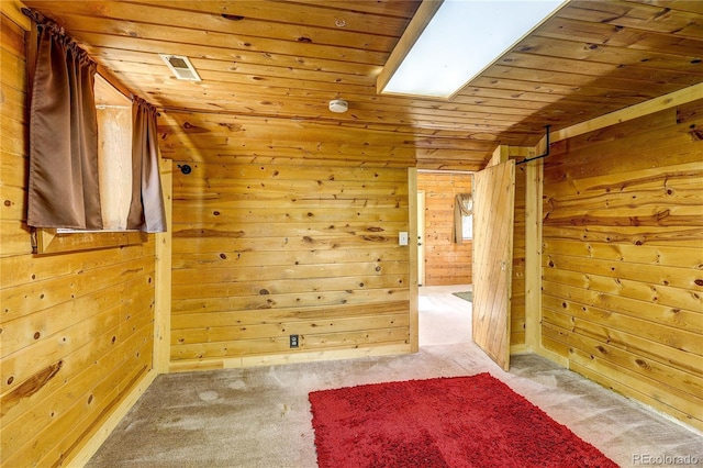 10893 Milliken Ave, Conifer, CO 80433 - empty room featuring wooden ceiling, wooden walls, and light colored carpet