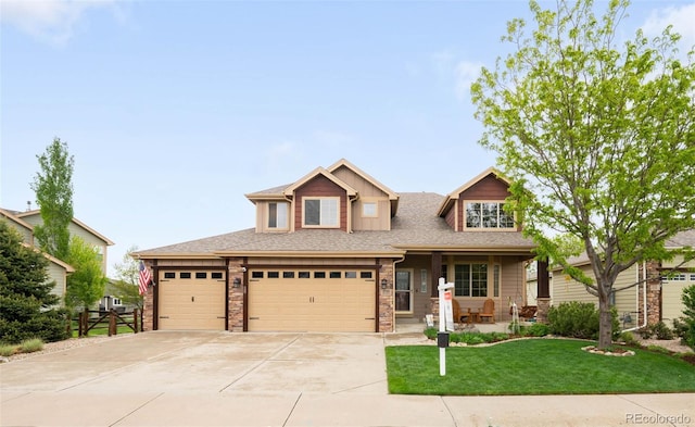 1719 Green River Dr, Windsor, CO 80550 - craftsman-style house with concrete driveway, covered porch, stone siding, a garage, and roof with shingles