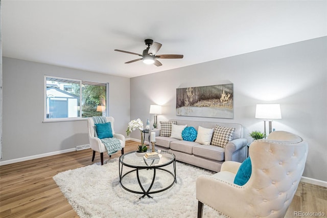 living room with ceiling fan and wood-type flooring