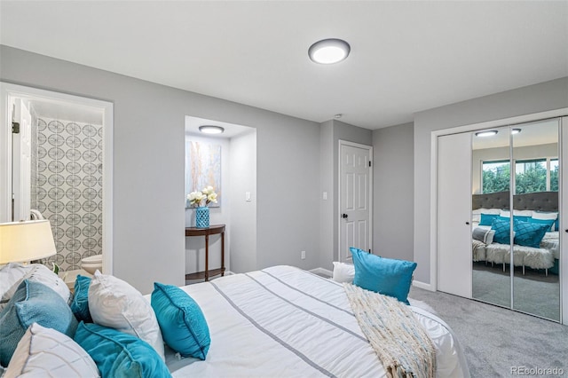 bedroom with light colored carpet and ensuite bath