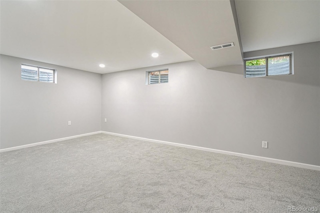 basement with a healthy amount of sunlight and carpet floors