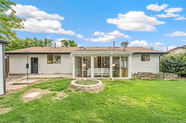 back of house featuring a lawn and a patio area