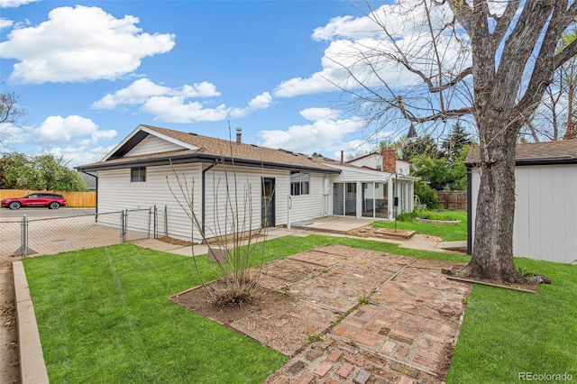 back of house featuring fence, a gate, a patio, and a yard