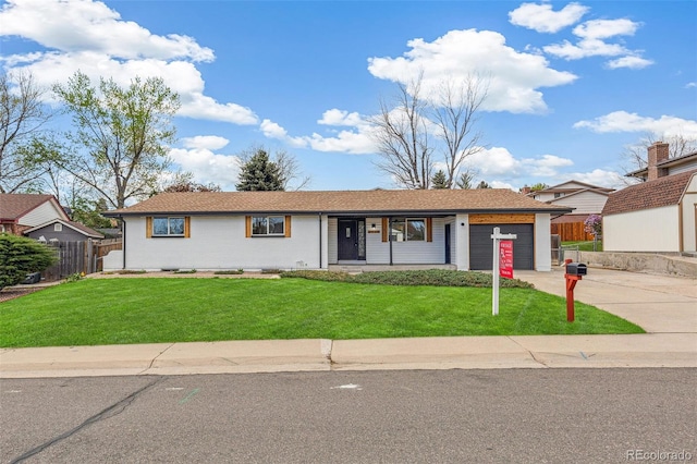 single story home featuring fence, an attached garage, concrete driveway, and a front lawn