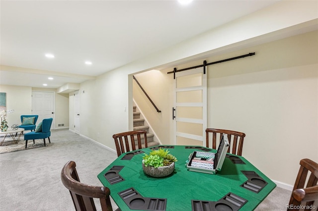 carpeted dining space with a barn door, stairs, recessed lighting, baseboards, and visible vents