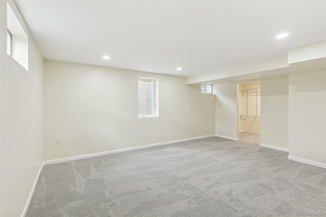 basement featuring baseboards, carpet, and recessed lighting