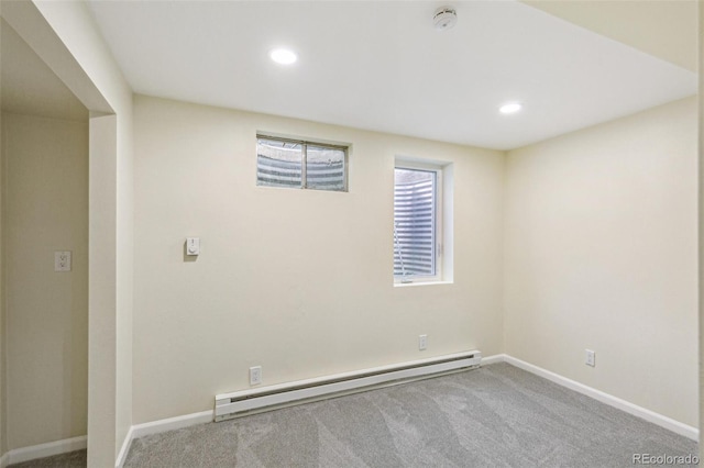 basement featuring carpet floors, recessed lighting, baseboards, and a baseboard radiator