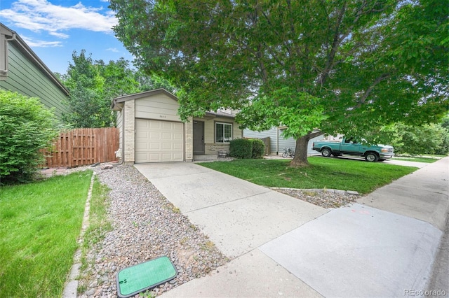 5602 S Yank Ct, Littleton, CO 80127 - view of front of home with driveway, a garage, and brick siding