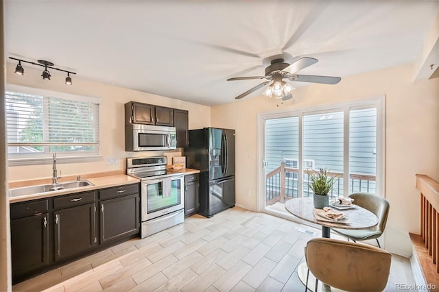 5602 S Yank Ct, Littleton, CO 80127 - kitchen featuring stainless steel appliances, light countertops, and a ceiling fan