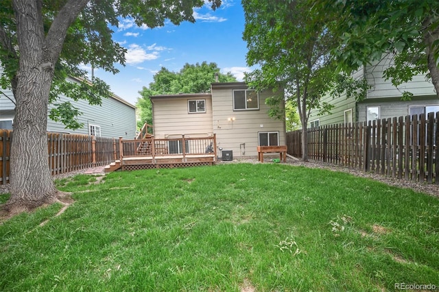 5602 S Yank Ct, Littleton, CO 80127 - rear view of house with a wooden deck and a fenced backyard