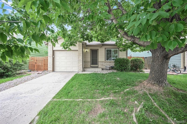 5602 S Yank Ct, Littleton, CO 80127 - view of front facade featuring brick siding, a garage, and driveway