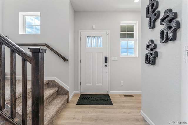 2110 Wagon Wheel Aly, Brighton, CO 80601 - foyer with light wood-style floors and stairs