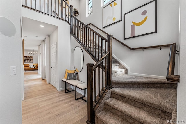 2110 Wagon Wheel Aly, Brighton, CO 80601 - staircase featuring wood finished floors, a chandelier, a towering ceiling, and recessed lighting