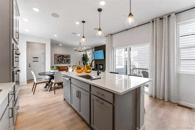 2110 Wagon Wheel Aly, Brighton, CO 80601 - kitchen featuring gray cabinetry, light countertops, light wood-type flooring, and recessed lighting