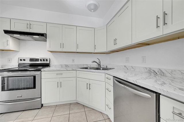 kitchen with light tile patterned floors, appliances with stainless steel finishes, sink, and white cabinets