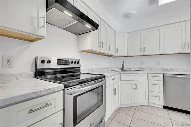 kitchen with sink, light tile patterned floors, appliances with stainless steel finishes, ventilation hood, and white cabinets