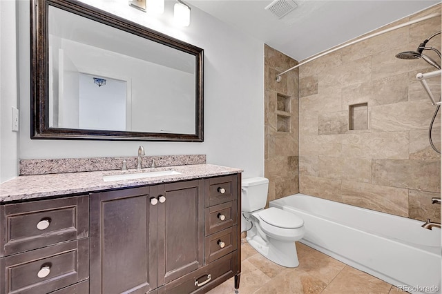 full bathroom with vanity, toilet, tiled shower / bath combo, and tile patterned flooring