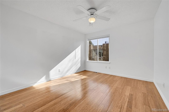 unfurnished room featuring ceiling fan, a textured ceiling, and light hardwood / wood-style flooring