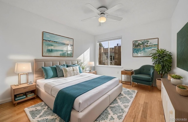 bedroom featuring ceiling fan and light hardwood / wood-style flooring