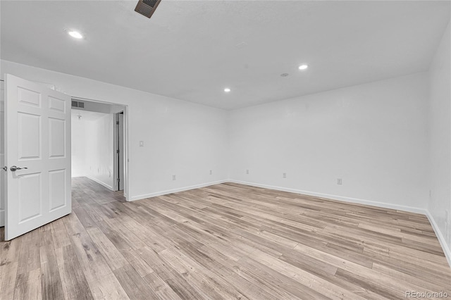 empty room with light hardwood / wood-style flooring