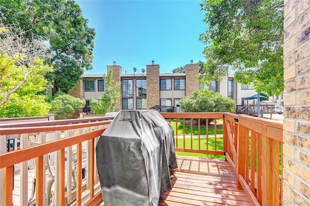 wooden terrace featuring grilling area