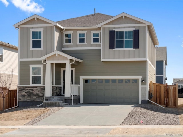 craftsman-style house with an attached garage, fence, board and batten siding, and driveway