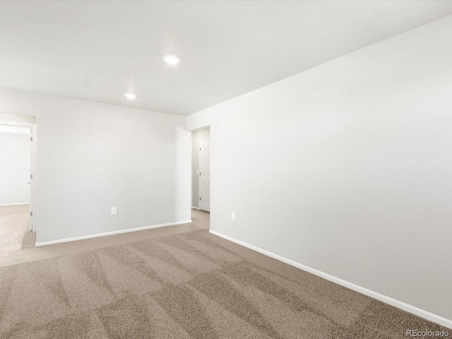 empty room with carpet flooring, recessed lighting, and baseboards