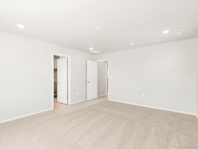 spare room with recessed lighting, visible vents, baseboards, and light carpet