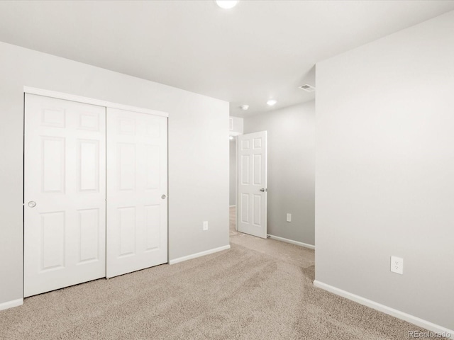 unfurnished bedroom with visible vents, recessed lighting, a closet, carpet floors, and baseboards